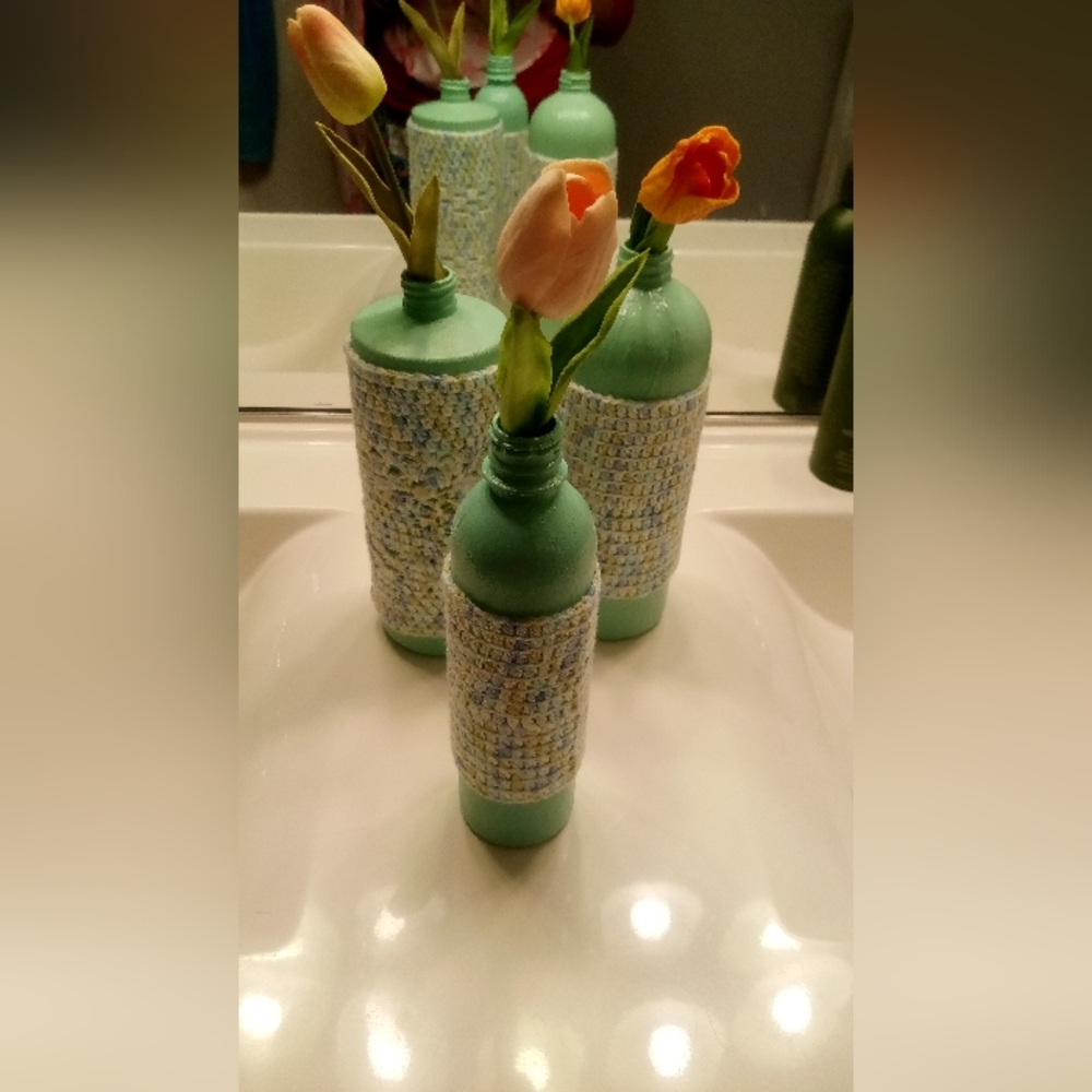 The 3 pictured Danish pastel Crocheted decor bottles with flowers included